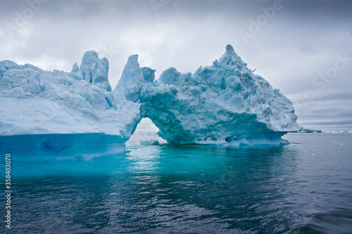 Iceberg arch in Disko Bay, Ilulissat, West Greenland photo
