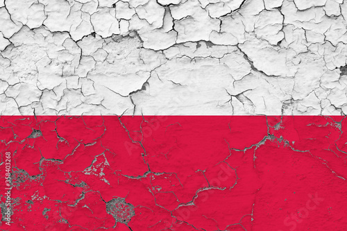 Poland flag close up grungy, damaged and weathered on wall peeling off paint to see inside surface. Vintage concept.