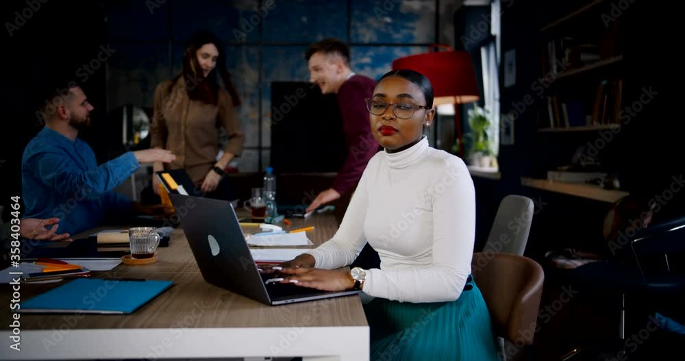 Zoom in portrait of happy young successful African boss business woman smiling at camera, working at modern loft office. Zoom in portrait of happy young successful African boss business woman smiling at camera, working at modern loft office.