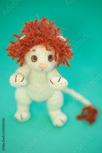 Portrait of white crocheting toy lion