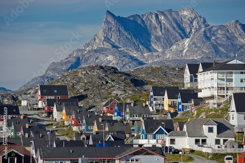 Rugged Mount Sermitsiaq looms above a colorful residential area in Nuuk, Greenland