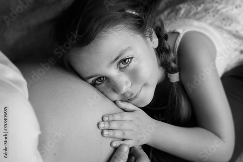 LITTLE GIRL WAITING FOR HER FUTURE BROTHER