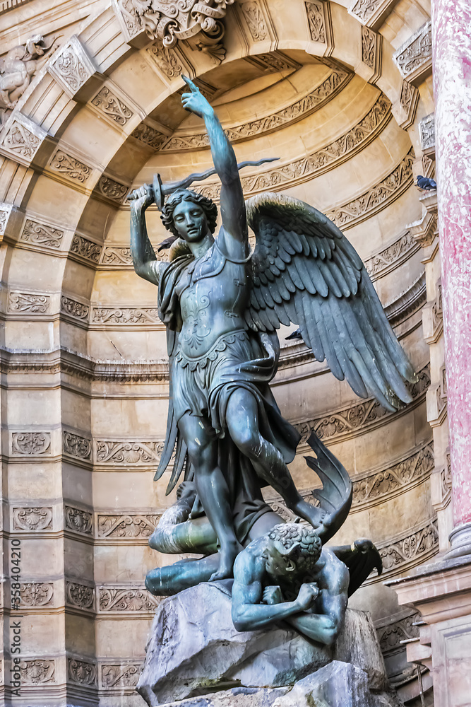 Obraz premium Sculpture of ancient Paris Fountain Saint-Michel at Place Saint-Michel. France. Fountain Saint-Michel constructed in 1858 - 1860 during French Second Empire. Paris, France.