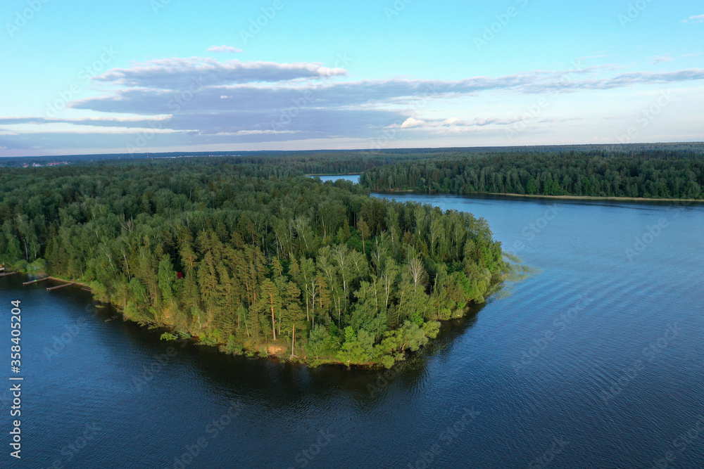 Naklejka premium natural landscape with river forest and fantastic clouds in the sky