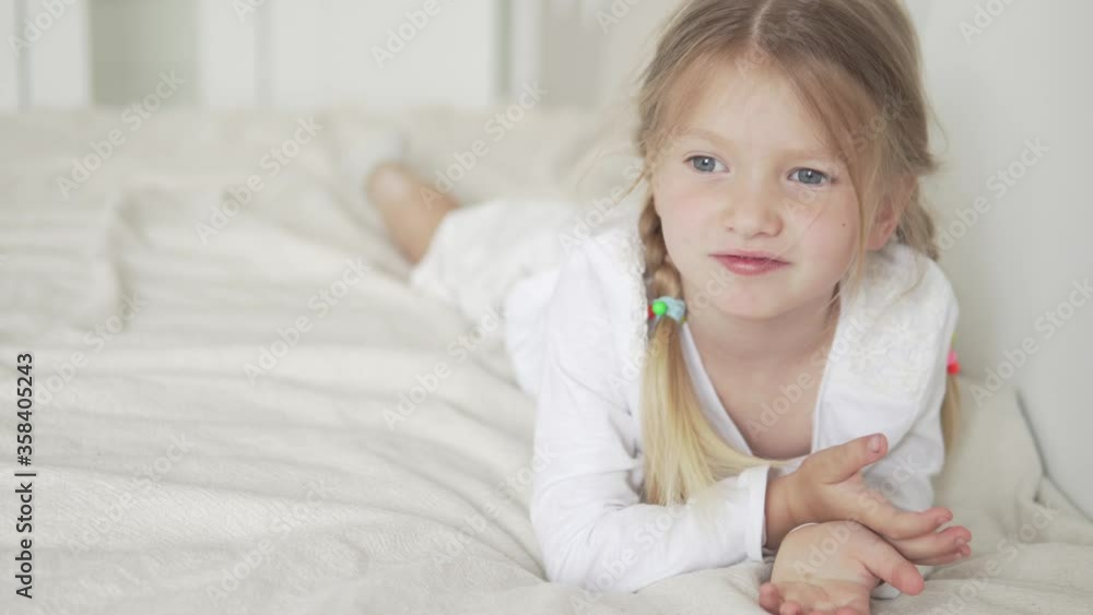 Funny little girl resting at home in bed. Funny little girl resting at home in bed.