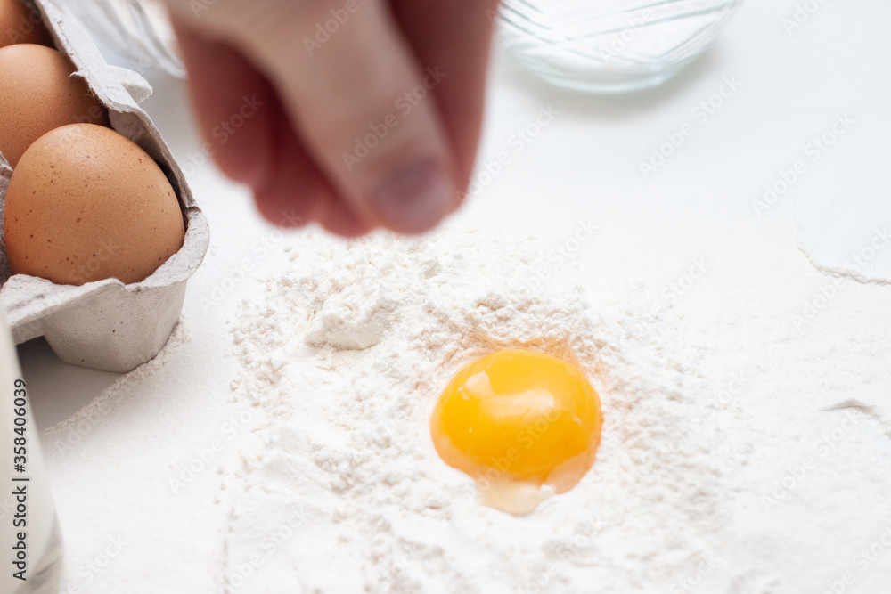 Baking ingredients: flour, eggs, sugar, butter, milk and spices on gray marble background Baking ingredients: flour, eggs, sugar, butter, milk and spices on gray marble background