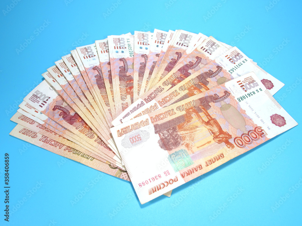 Fan style layout of Russian five thousand nominal rubles, many banknotes on blue background Fan style layout of Russian five thousand nominal rubles, many banknotes on blue background