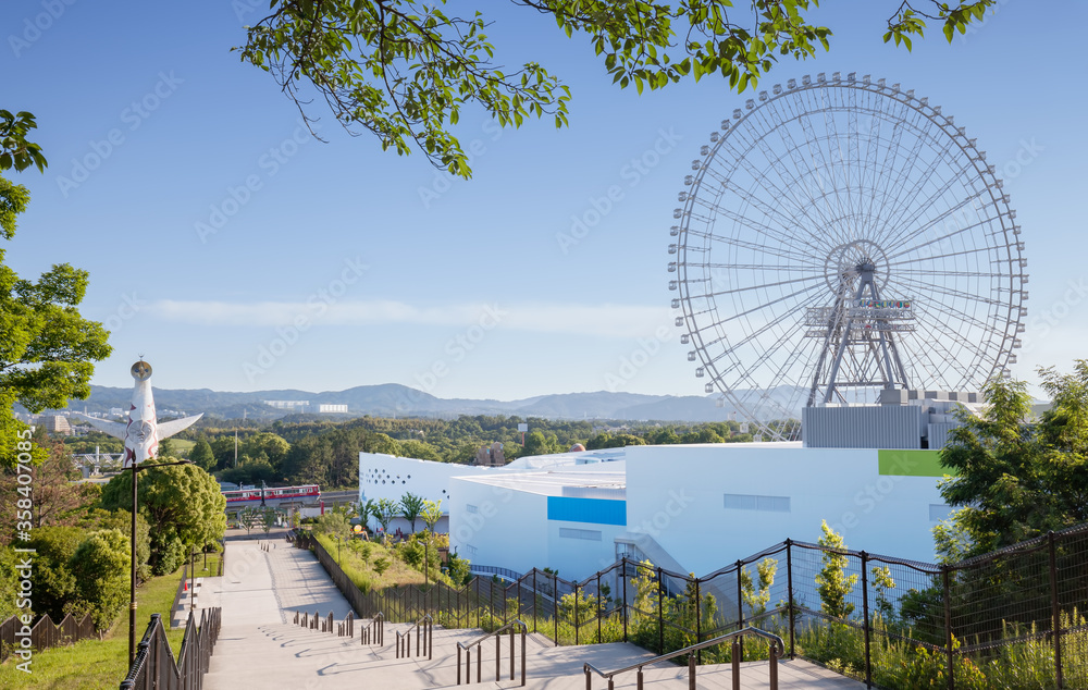 High-angle view of Expocity shopping mall, Redhorse Osaka Wheel, Tower of the Sun in Expo '70 Commemoration Park, and Osaka Monorail High-angle view of Expocity shopping mall, Redhorse Osaka Wheel, Tower of the Sun in Expo '70 Commemoration Park, and Osaka Monorail