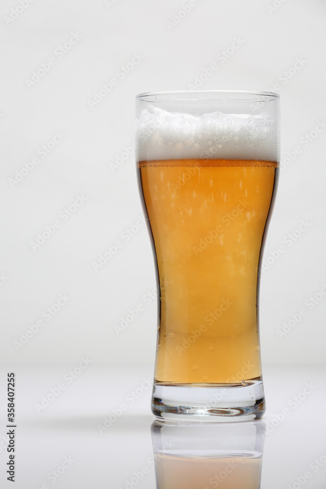 Large glass of beer on a light background Large glass of beer on a light background
