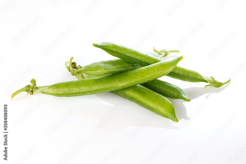 Pods of green peas with pea leaves and flowersd on a white background. Organic food. Full depth of field. Pods of green peas with pea leaves and flowersd on a white background. Organic food. Full depth of field.