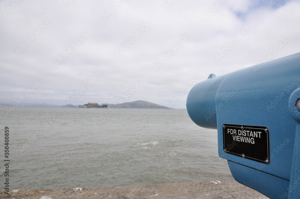 Telescope for tourists to explore the island of Alcatraz from the coast of San Francisco.