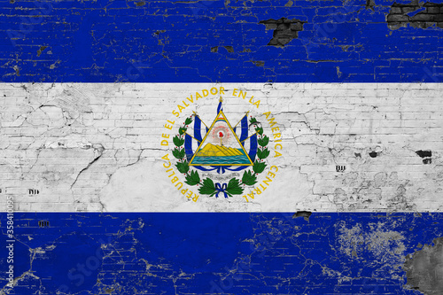 El Salvador flag on grunge scratched concrete surface. National vintage background. Retro wall concept.