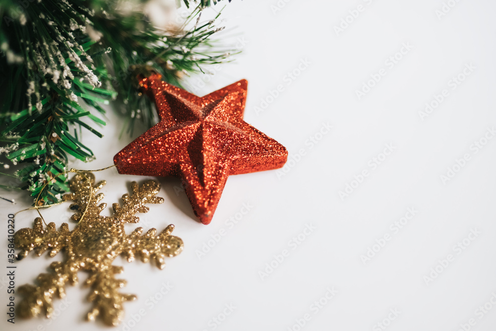 Christmas tree branches decorated with toys red star, snowflake. white background, copy space Christmas tree branches decorated with toys red star, snowflake. white background, copy space