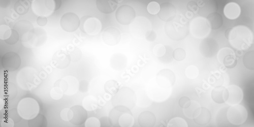 Abstract background with bokeh effects in white and gray colors