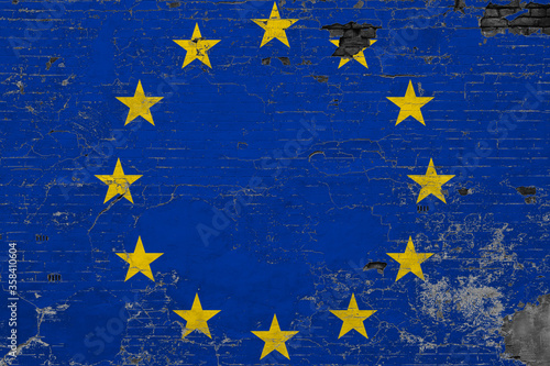 European Union flag on grunge scratched concrete surface. National vintage background. Retro wall concept.