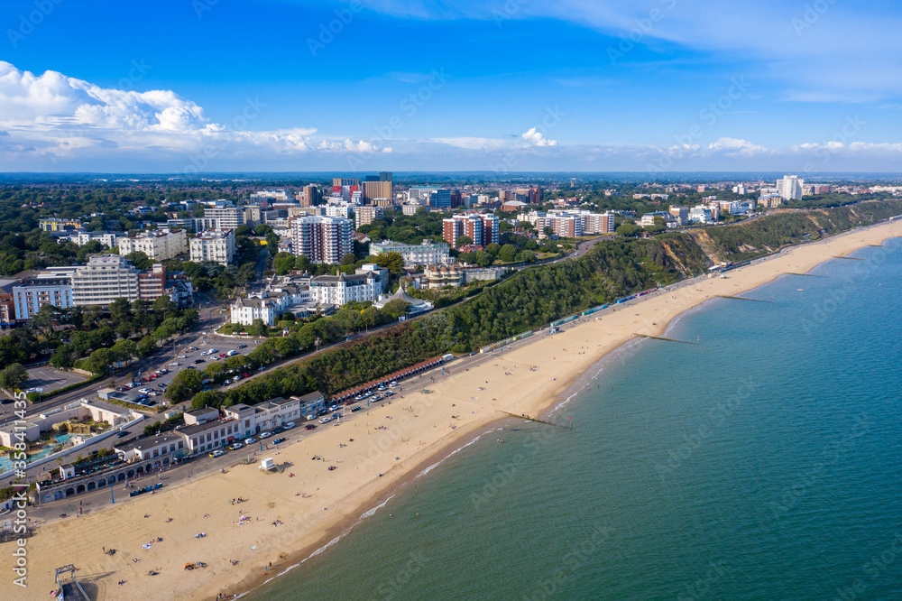 Fototapeta premium Aerial drone photo of the Bournemouth beach and town centre on a beautiful sunny summers day showing people on the sandy beach on the British sunny beach