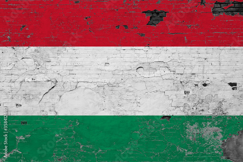 Hungary flag on grunge scratched concrete surface. National vintage background. Retro wall concept.