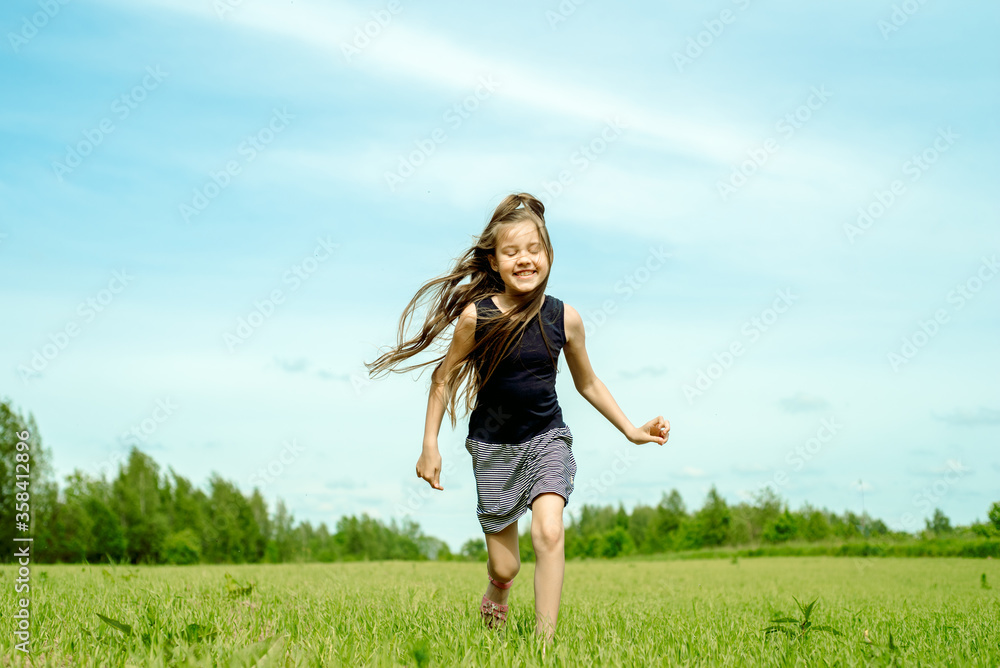 Little girl running on a meadow in a field of flowers, Freedom, happiness and wind in your hair. Little girl running on a meadow in a field of flowers, Freedom, happiness and wind in your hair.