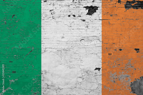 Ireland flag on grunge scratched concrete surface. National vintage background. Retro wall concept. © sezerozger