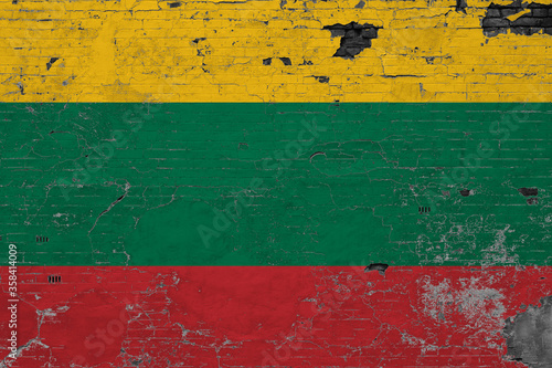 Lithuania flag on grunge scratched concrete surface. National vintage background. Retro wall concept.