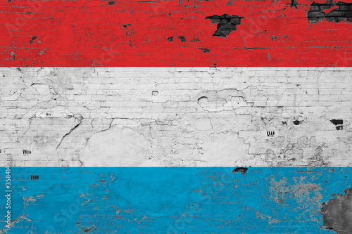 Luxembourg flag on grunge scratched concrete surface. National vintage background. Retro wall concept.