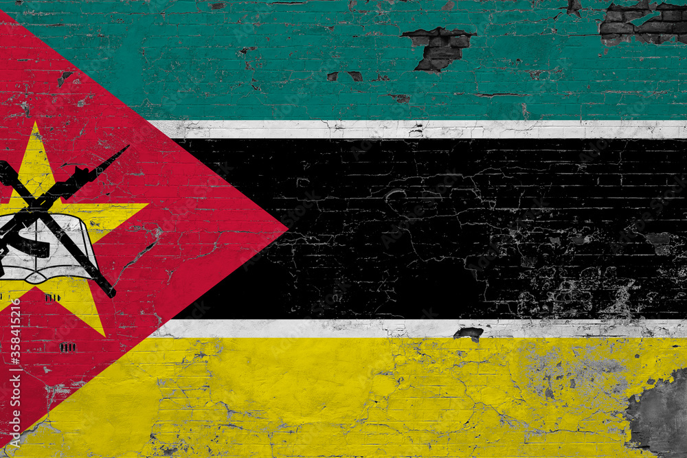 Mozambique flag on grunge scratched concrete surface. National vintage background. Retro wall concept.