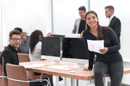 Wallpaper Mural smiling young business woman standing near the desktop Torontodigital.ca