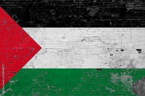 Palestine flag on grunge scratched concrete surface. National vintage background. Retro wall concept.