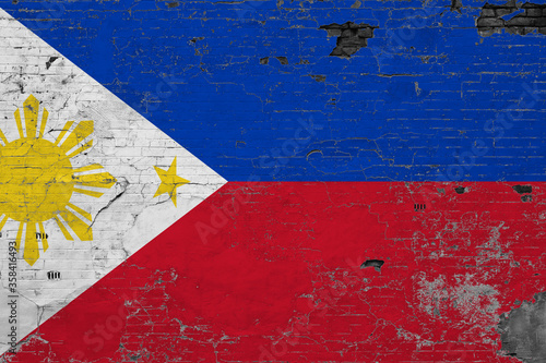 Philippines flag on grunge scratched concrete surface. National vintage background. Retro wall concept.