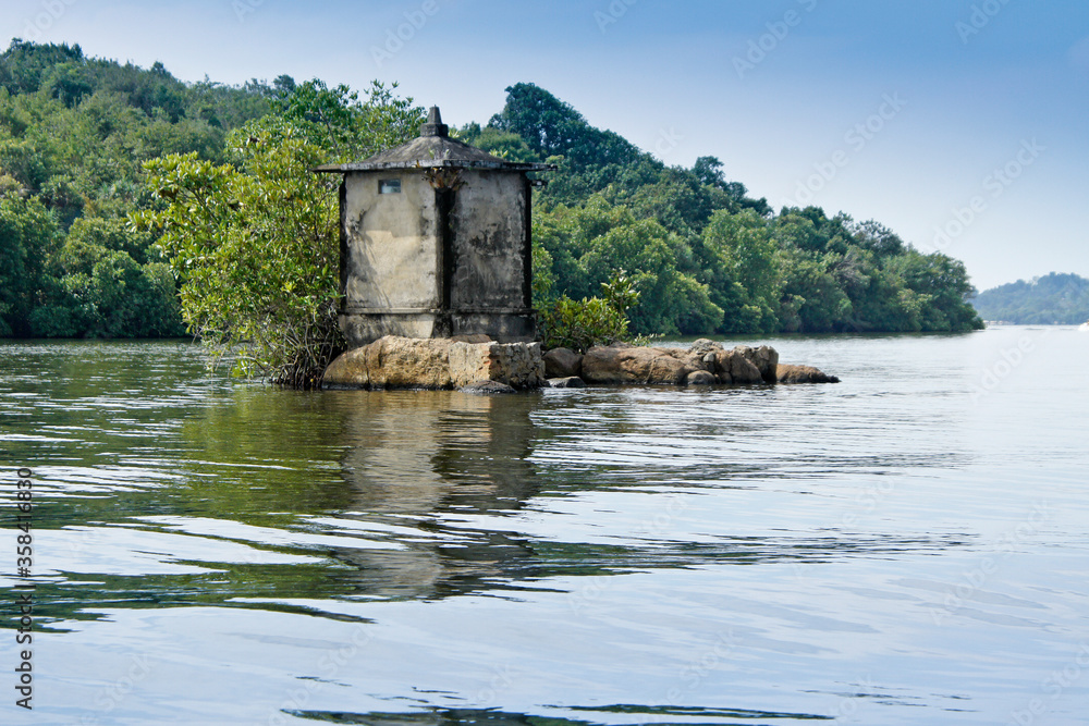 Buddhist shrine on small island in Maduwa River (Madu Ganga), Sri Lanka Buddhist shrine on small island in Maduwa River (Madu Ganga), Sri Lanka