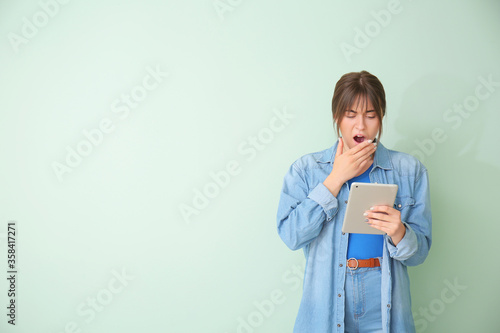 Tired woman with tablet com...