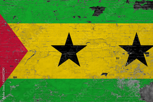 Sao Tome And Principe flag on grunge scratched concrete surface. National vintage background. Retro wall concept.