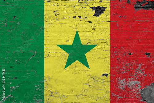 Senegal flag on grunge scratched concrete surface. National vintage background. Retro wall concept.