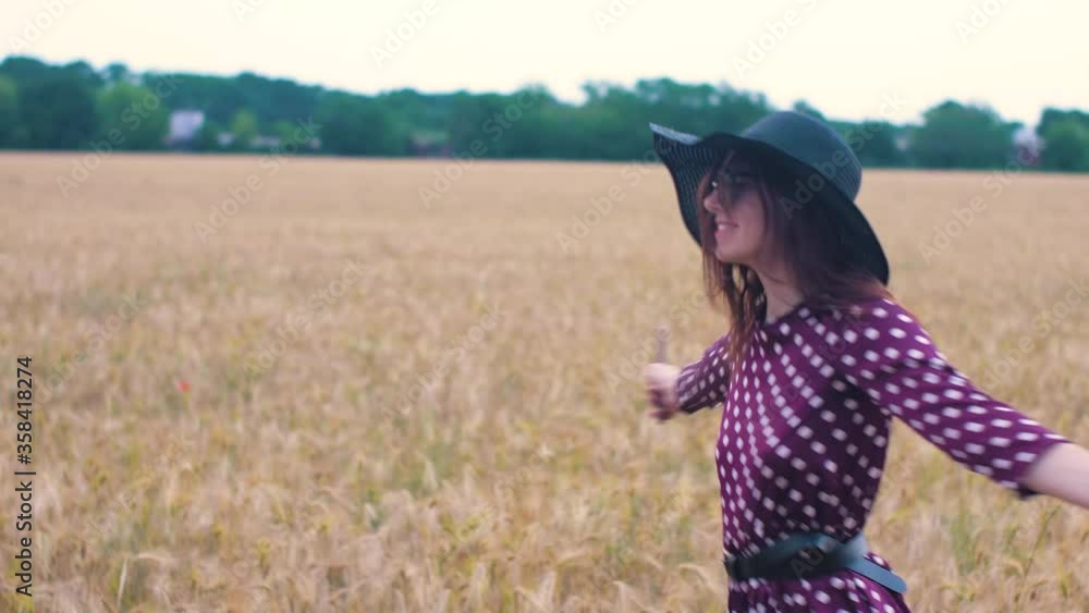 Beautiful young woman walks in a wheat field. Woman have fun in the field. Beautiful young woman walks in a wheat field. Woman have fun in the field.