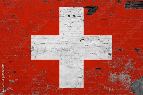 Switzerland flag on grunge scratched concrete surface. National vintage background. Retro wall concept.