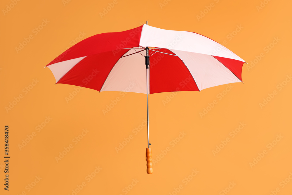 Stylish umbrella on color background