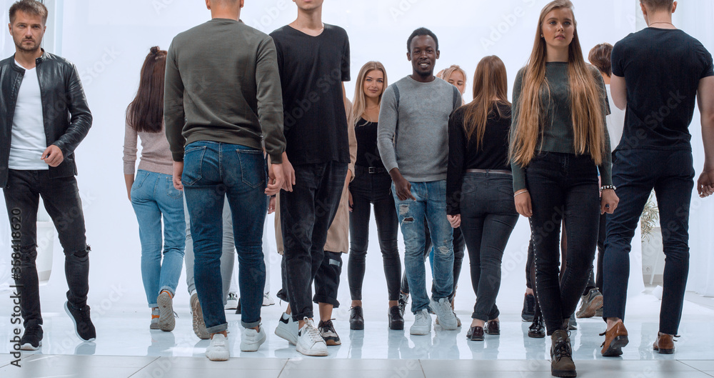 groups of diverse young men striding towards each other groups of diverse young men striding towards each other