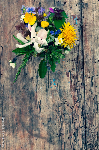 Close-up of a bouquet of wildflowers on a wooden background. selective focus, place for text