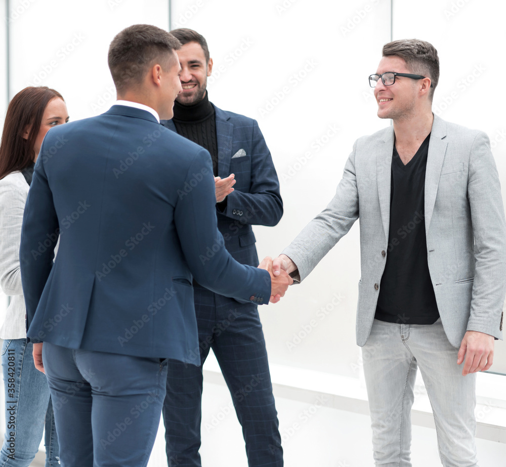 business people greeting each other with a handshake business people greeting each other with a handshake