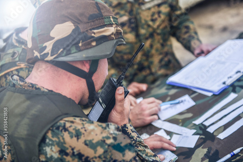 an officer from the command center talks into the radio and cooperates with his assistants