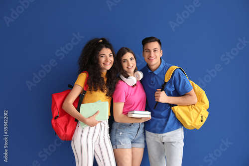 Young students on color bac...