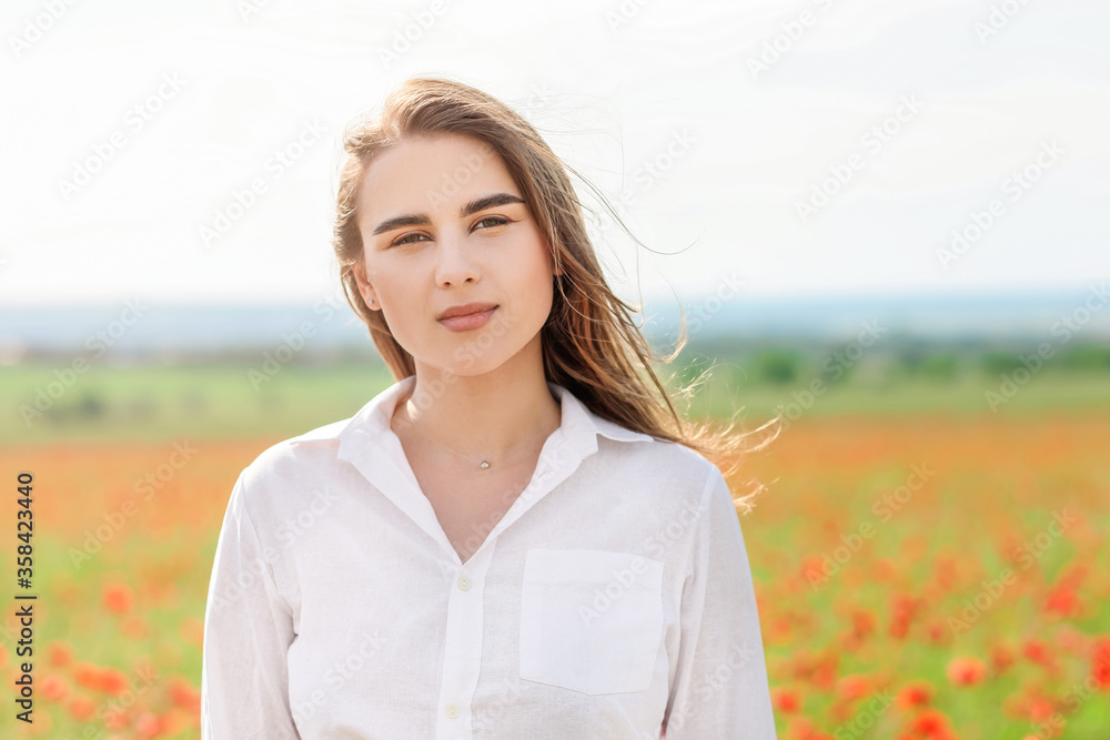 Beautiful young woman in poppy field Beautiful young woman in poppy field