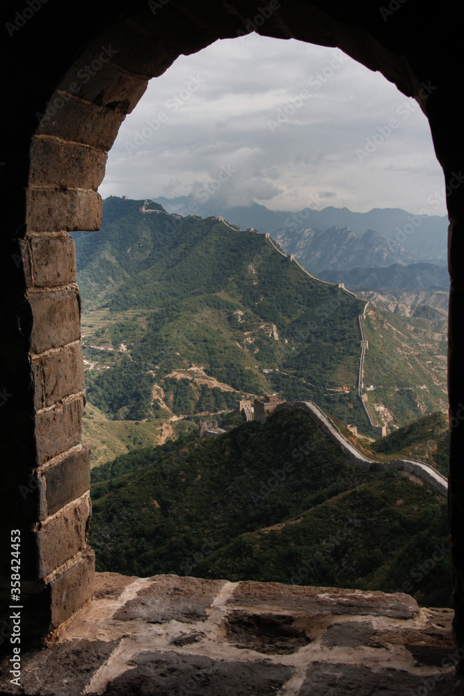 Panorama of the Great Wall of China seen from inside a defensive tower (Simatai). The most famous landmark in China