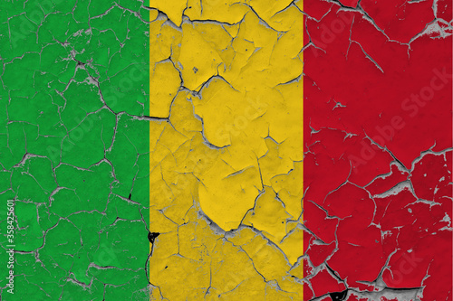 Mali flag close up grungy, damaged and scratched on wall peeling off paint to see inside surface. Vintage National Concept.