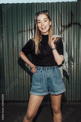 beautiful stylish blonde girl walks after party flash architecture