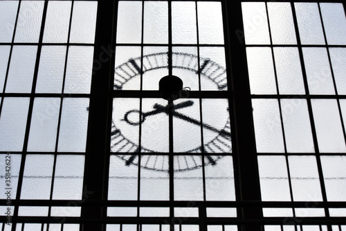 old clock in a train station window in Europe. clock in the window