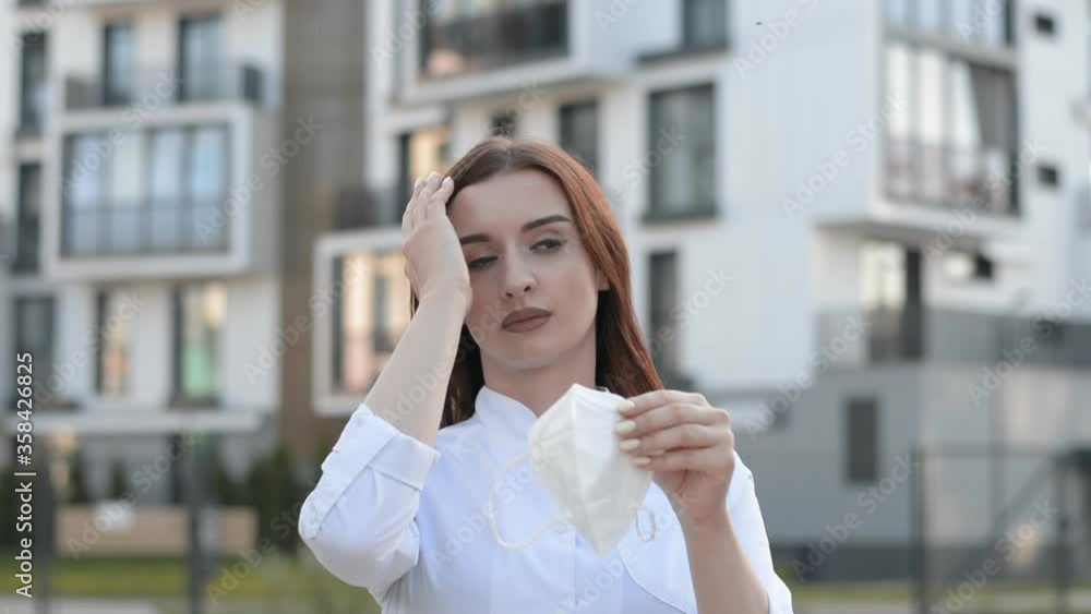 beautiful girl doctor puts on a protective mask outdoor beautiful girl doctor puts on a protective mask outdoor