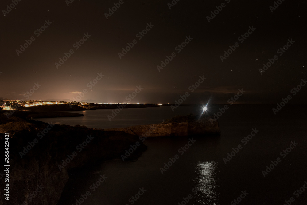 Sea and coast landscape in the night with lighthouse in Porto Cristo Sea and coast landscape in the night with lighthouse in Porto Cristo