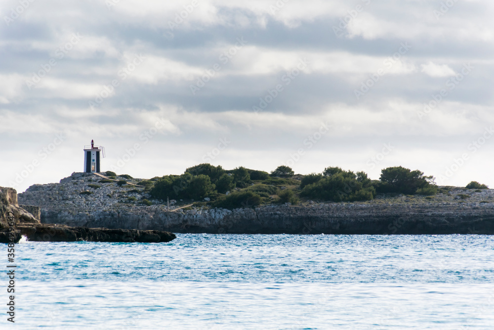 Sea and coast landscape with lighthouse in Porto Cristo