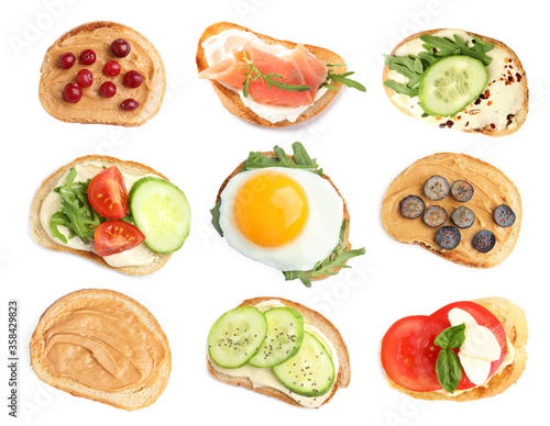 Fototapeta Naklejka Na Ścianę i Meble -  Set of toasted bread with different toppings on white background, top view